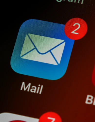 Mail app icon with unread messages on smartphone screen, representing Business Email Compromise and phishing email risks